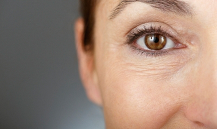 Close-up of a person's eye showing details of the iris and fine lines around the eye.