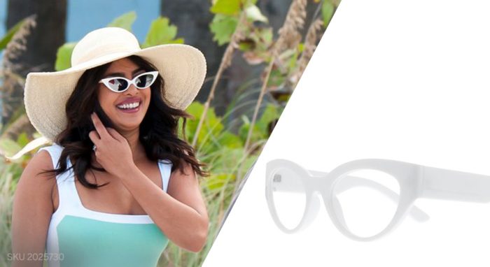 Woman wearing cat-eye white sunglasses paired with a wide-brimmed hat. SKU 2025730.