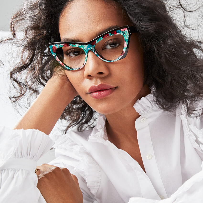 Woman wearing cat-eye glasses with a colorful floral frame.