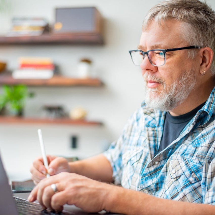 Man using a stylus on a laptop.