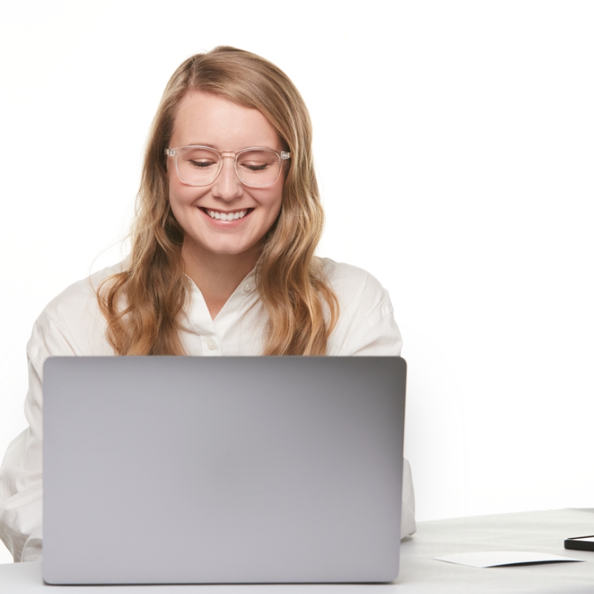 Smiling woman using a laptop.