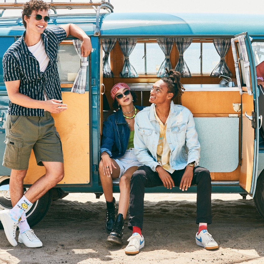 Casual summer footwear and clothing collection. White sneakers with colorful socks, combat boots, and denim jackets.