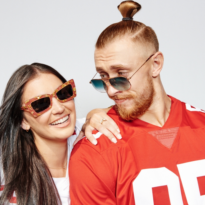 Two people wearing stylish sunglasses and red football jerseys.