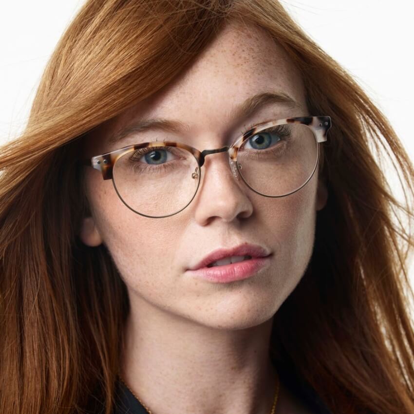 Person wearing tortoiseshell round eyeglasses.