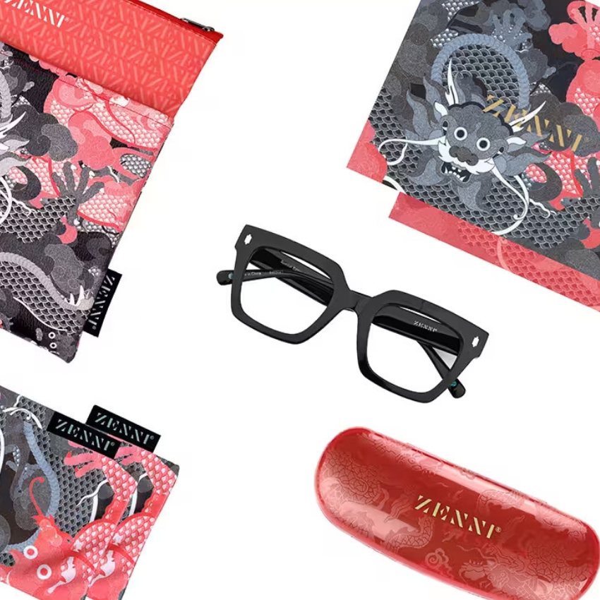 Black eyeglasses with Zenni logo, red eyeglasses case with Zenni logo, and red-patterned eyeglasses pouches.