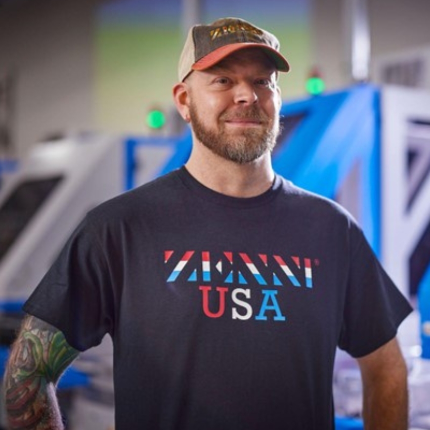 Man wearing a Zenni USA shirt and a cap.