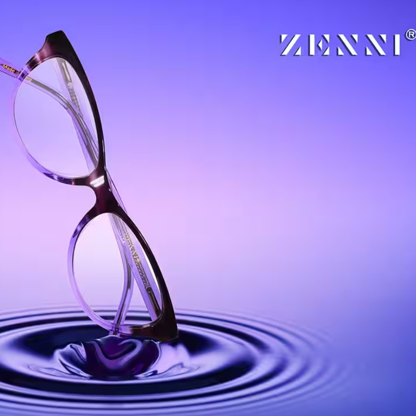 Purple eyeglasses positioned vertically in water ripple. Zenni branding in upper right corner.