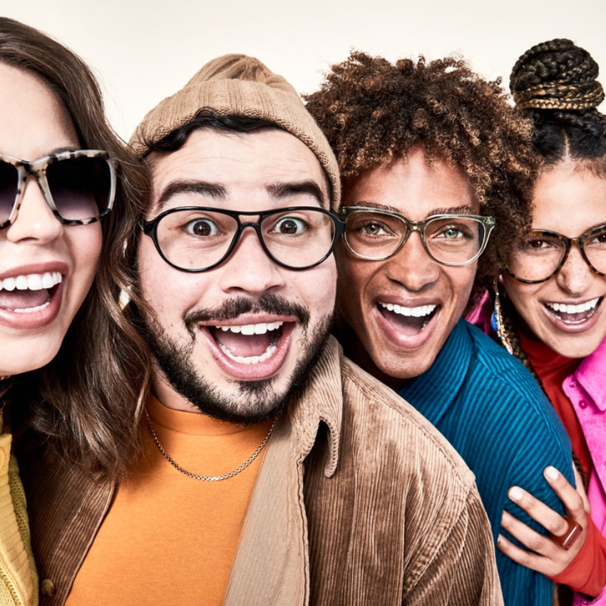 Four individuals wearing stylish eyeglasses, smiling and looking directly at the camera.