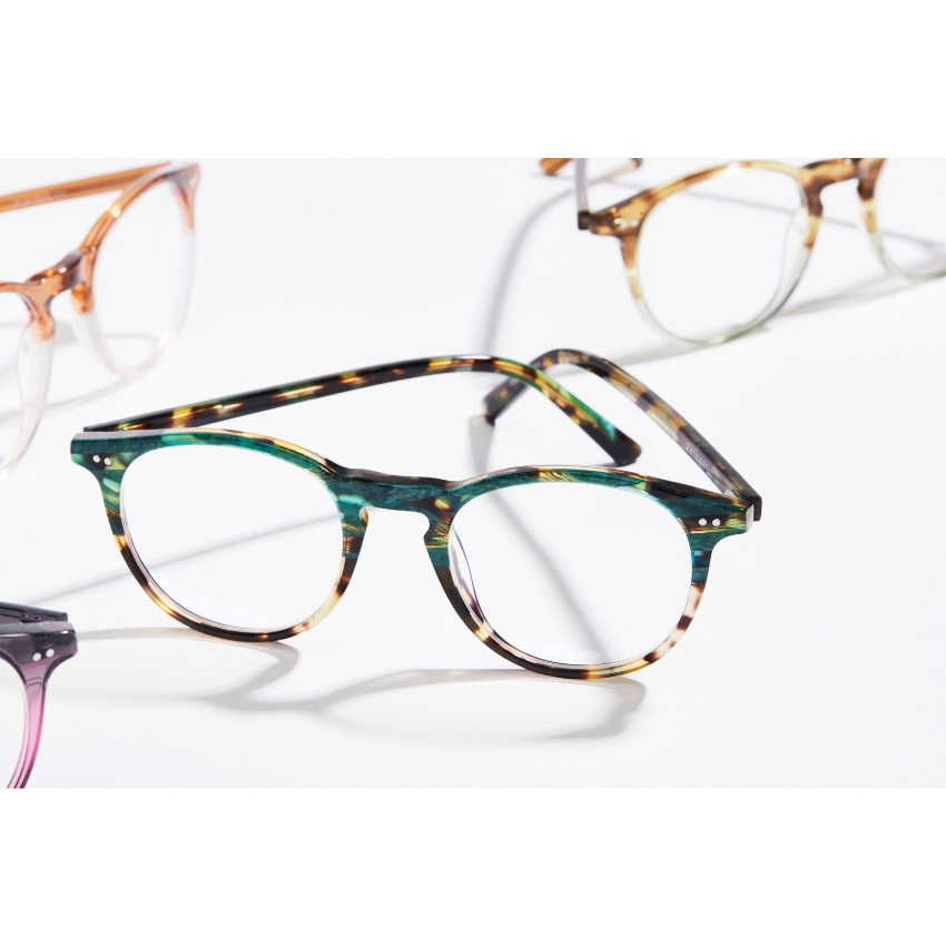 Tortoiseshell round eyeglasses with green and brown pattern accents.