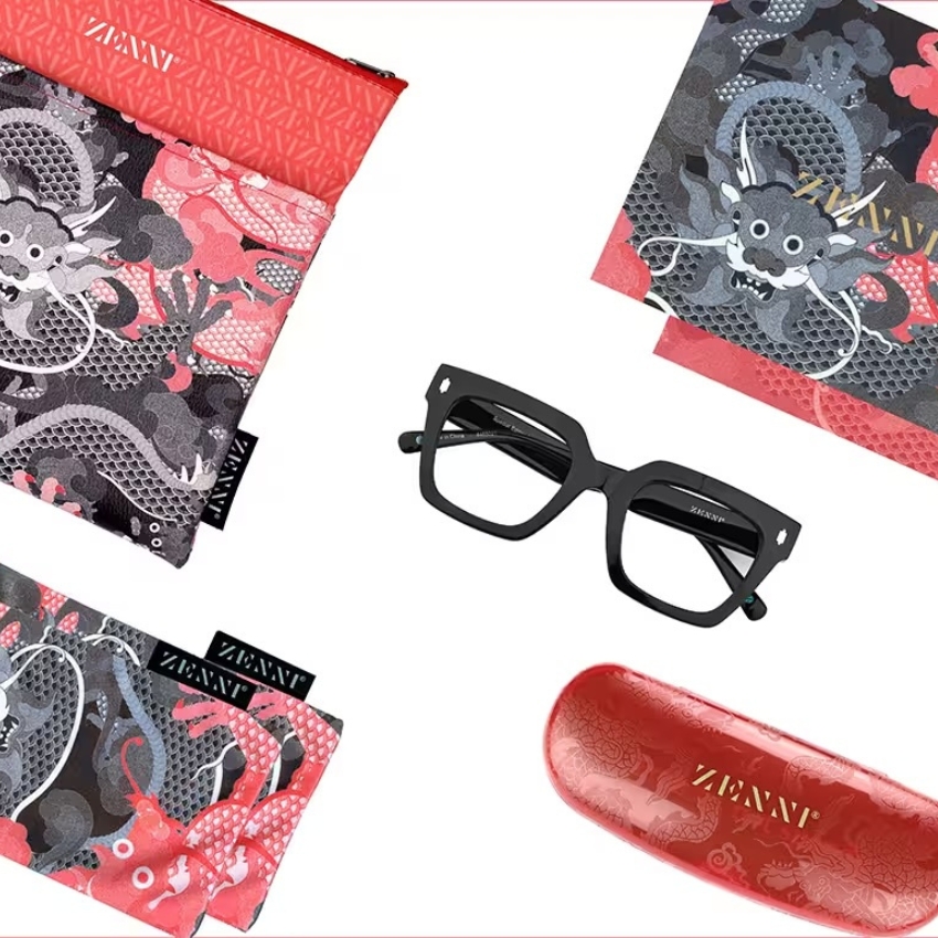 Zenni glasses with case, cleaning cloth, and pouch featuring dragon designs. Zenni branding on all items.