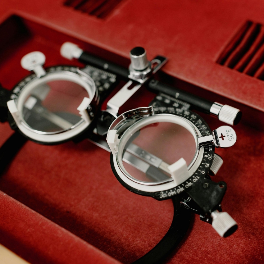 Phoropter glasses with dials and lenses, one lens marked with +3.25