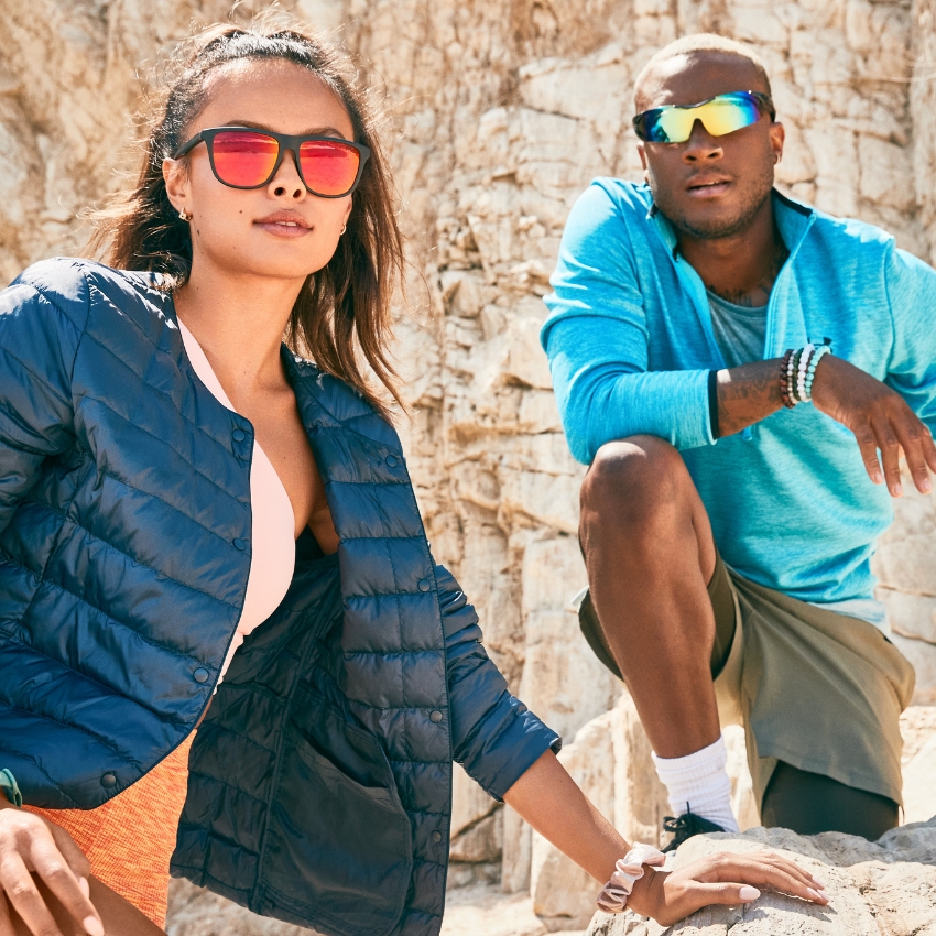 Two people wearing reflective sunglasses in an outdoor setting.