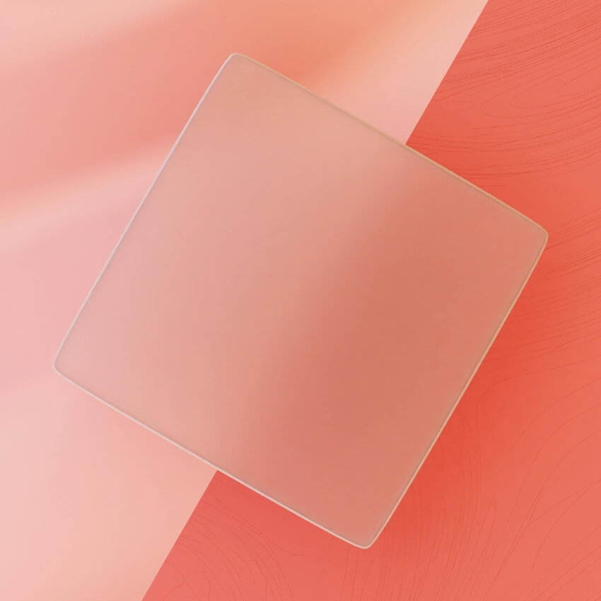 Square, light pink, frosted glass plate on a pink and peach background.