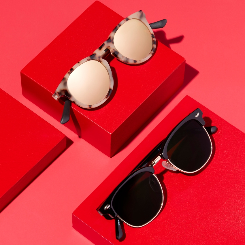 Two pairs of sunglasses: one with tortoiseshell frames and round lenses, the other with black frames and rectangular lenses.