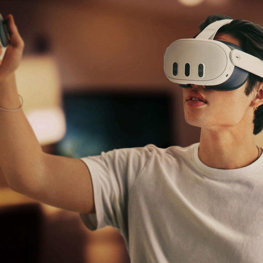 Person wearing a white virtual reality headset and holding a controller.