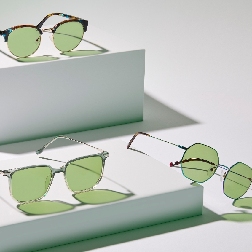 Three pairs of sunglasses with green lenses in different frame styles: round, square, and hexagonal.