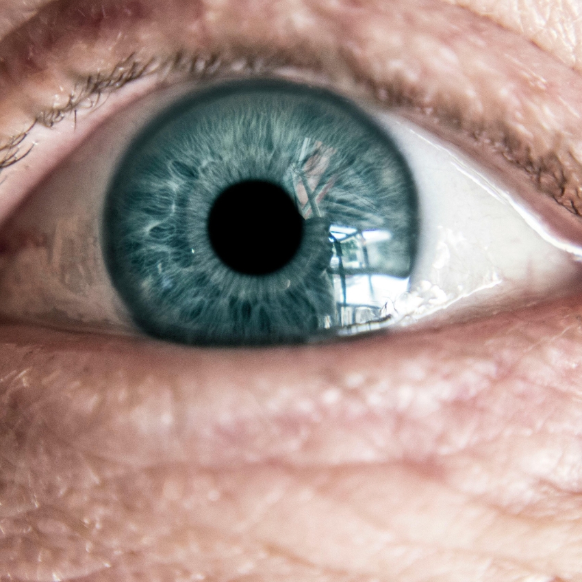 Close-up of a blue eye with detailed iris and pupil.