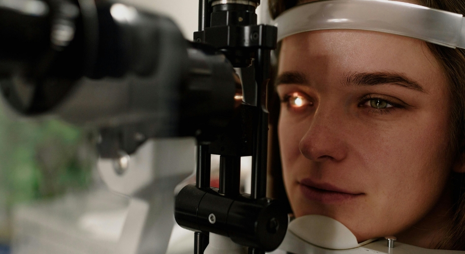 Girl getting her eyes examined in a slit lamp