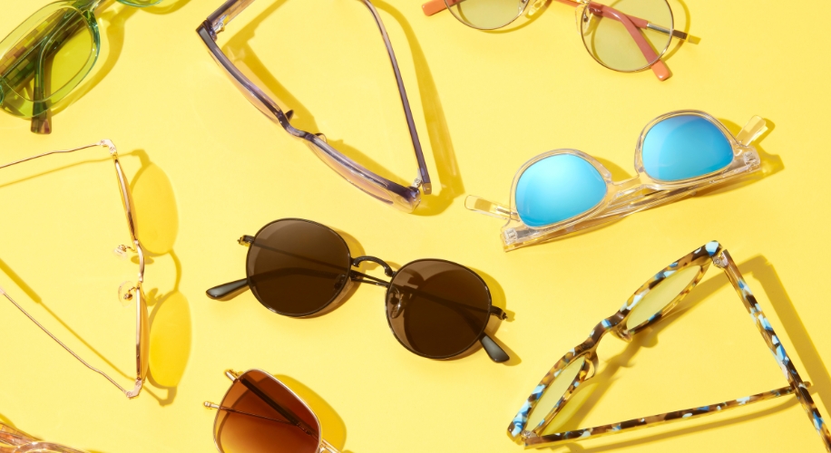 A collection of sunglasses with a yellow background