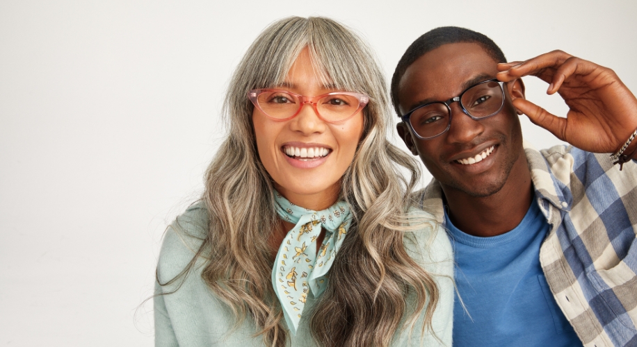 Two people wearing glasses and smiling