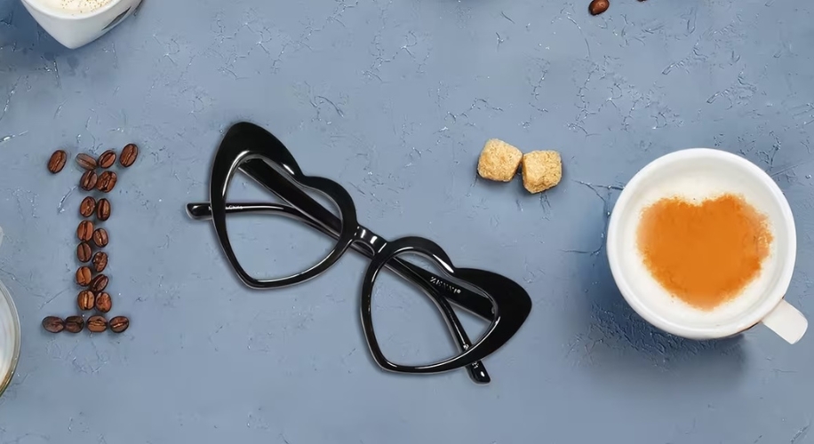 Heart shaped glasses next to coffee cup