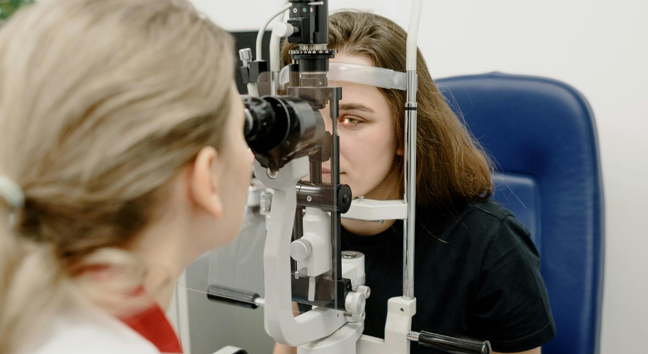 Woman getting eyes examined by doctor