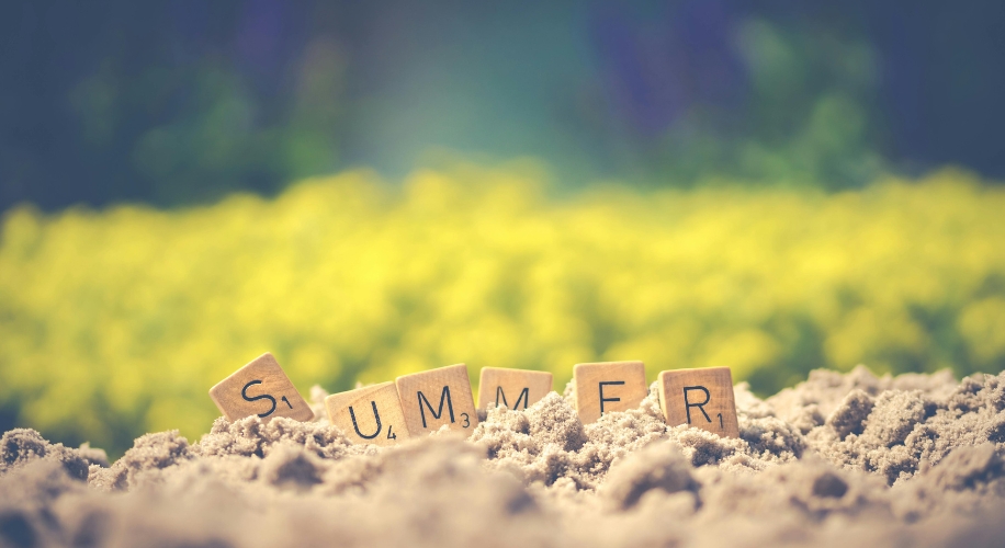 Summer letter blocks on sand
