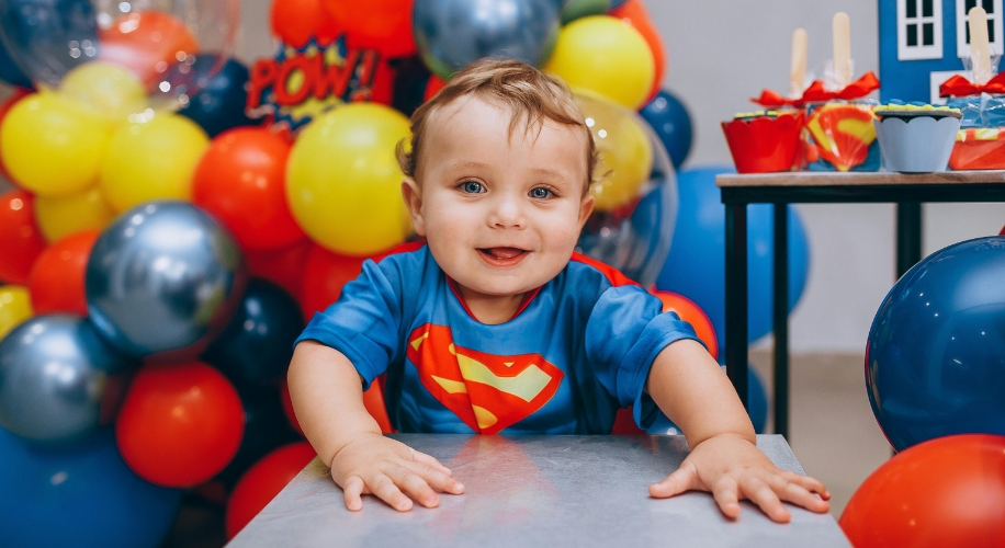 a toddler wearing a superman shirt