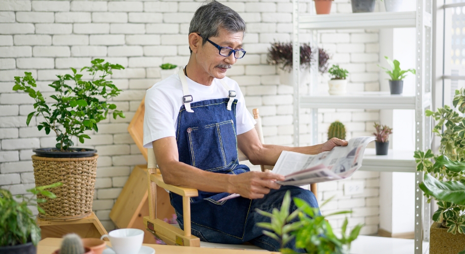 Man reading the newspaper with reading glasses