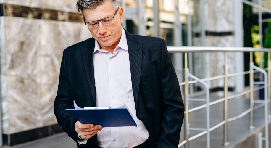 businessman in glasses attentively reading document