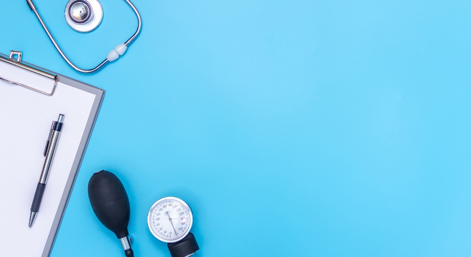 Stethoscope and clipboard isolated on blue background