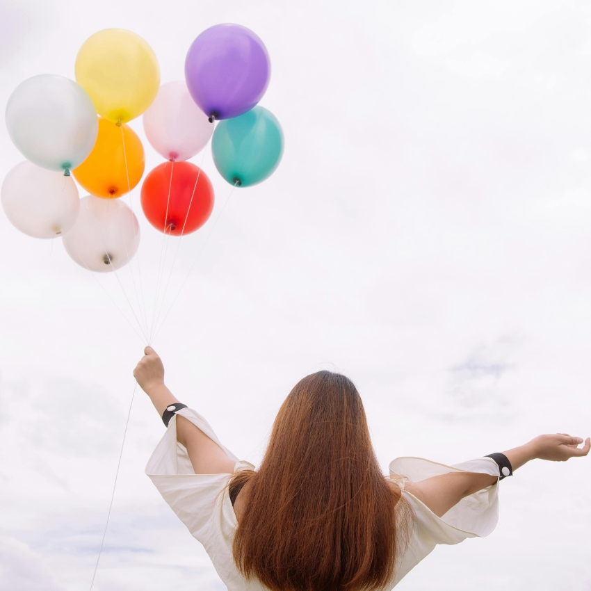 woman-holding-balloons_Featured Image