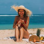 woman-on-beach-wearing-sunscreen_Featured Image