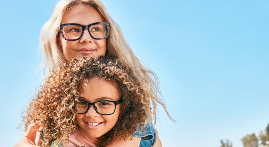 Mother and daughter wearing stylish black-rimmed glasses.