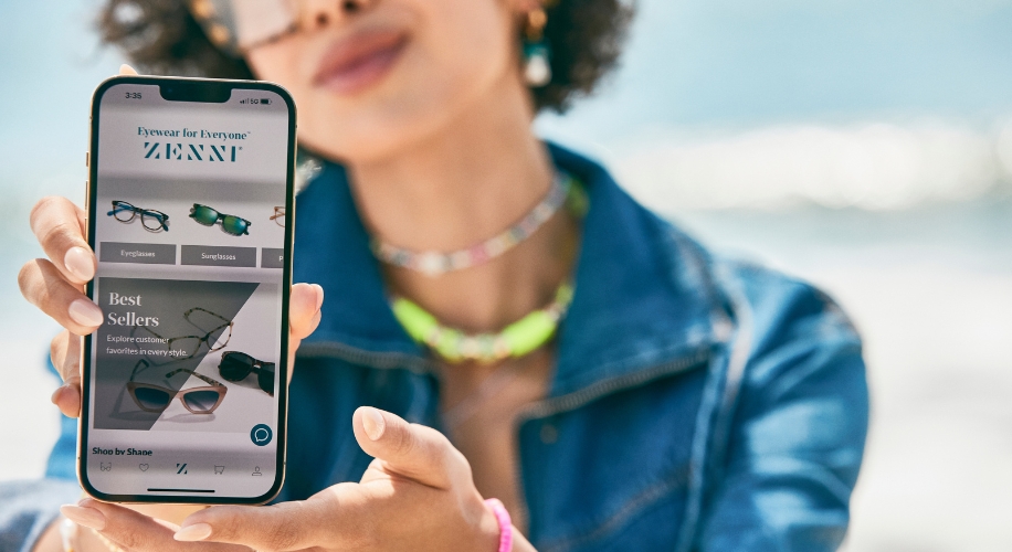 Smartphone screen displaying Zenni&#039;s website with &quot;Eyewear for Everyone,&quot; and &quot;Best Sellers; Explore customer favorites in every style.&quot;