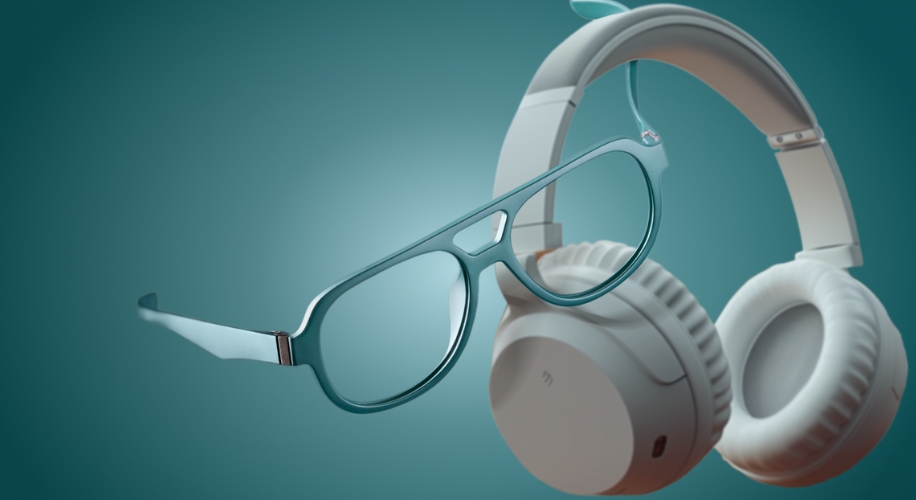 Glasses with teal frames and white over-ear headphones against a teal background.