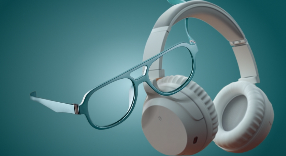 Teal eyeglasses and white over-ear headphones floating on a teal background.