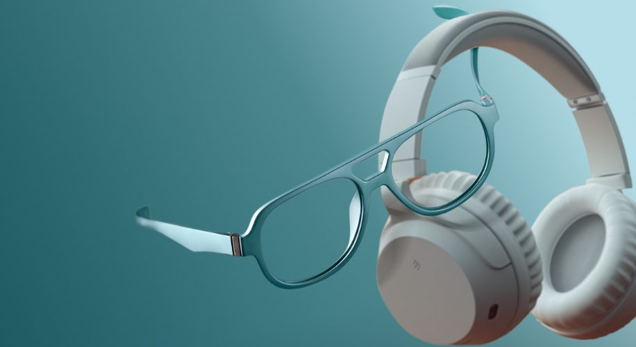 Teal-colored eyeglasses and white over-ear headphones on a teal gradient background.