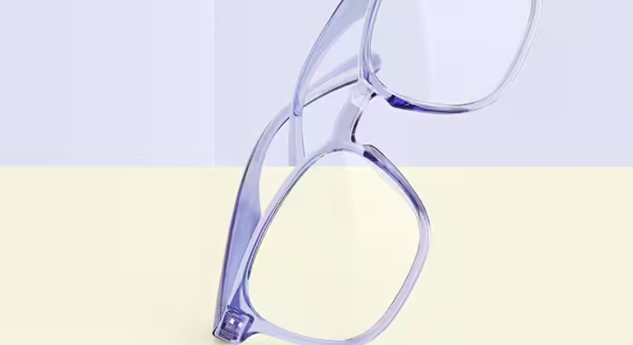 Translucent purple eyeglasses with rectangular lenses, balancing on two of the frame edges.