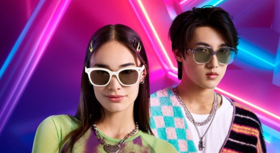 Two people modeling fashionable sunglasses with gradient neon lights in the background.