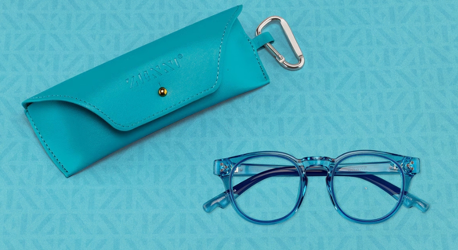 Blue eyeglasses with clear frames paired with a matching turquoise leather case labeled &quot;ZIMZANI&quot;.