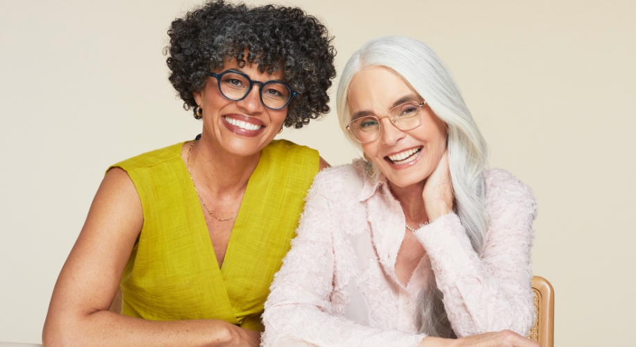 Two women wearing reading glasses