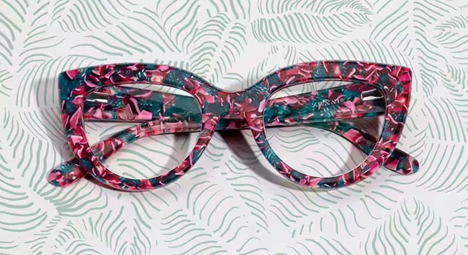 Cat-eye glasses with a pink, green, and black marbled pattern.