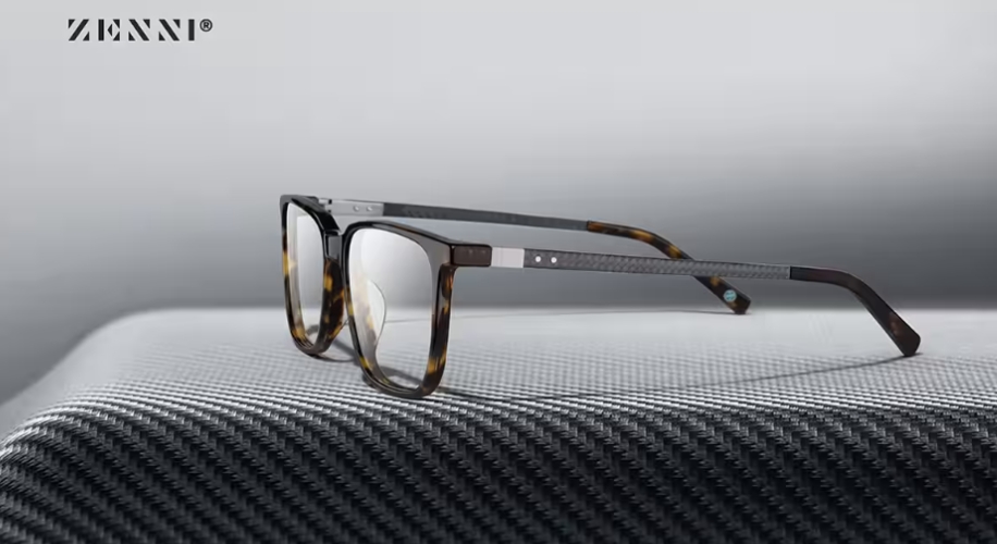 Zenni glasses with black and tortoiseshell frame on a textured surface.