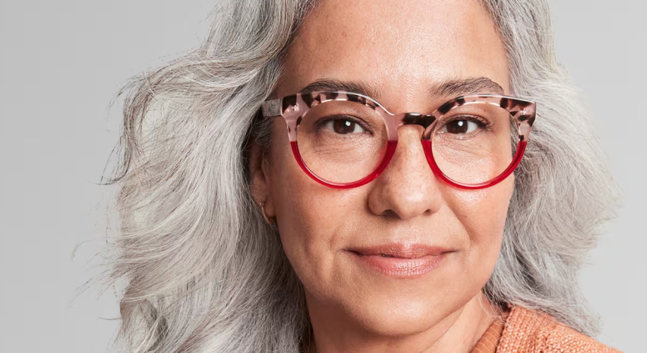 Woman wearing tortoiseshell glasses with red accents.