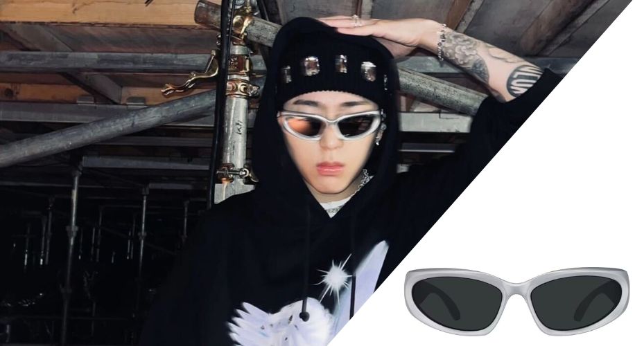 Person wearing black hoodie and black beanie with silver embellishments, modeling silver wraparound sunglasses. Close-up of sunglasses on the right.