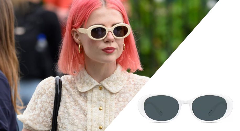 White oval sunglasses with dark lenses worn by a person with pink hair.