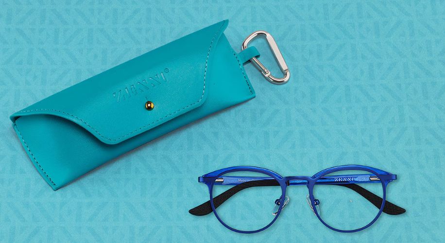 Blue eyeglasses with black temple tips and a turquoise leather case with &quot;ZENNI&quot; embossed on it.