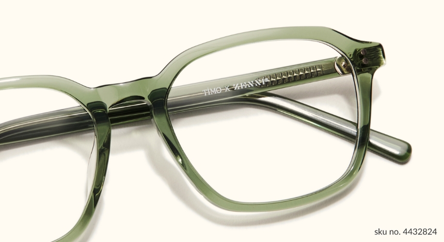 Green semi-transparent eyeglasses with &quot;TIMO x ZANZAN&quot; on the arm. SKU no. 4432824.