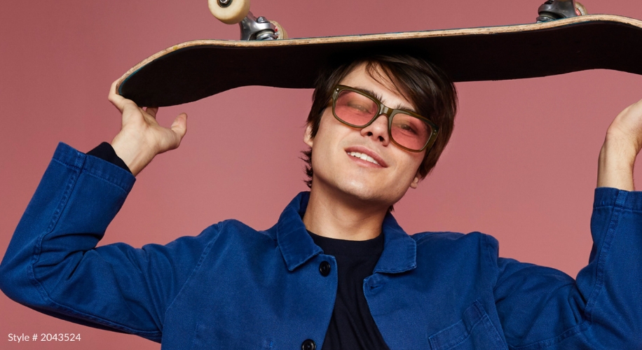 Person holding skateboard overhead, wearing sunglasses and a blue jacket. Text: Style #2043524.